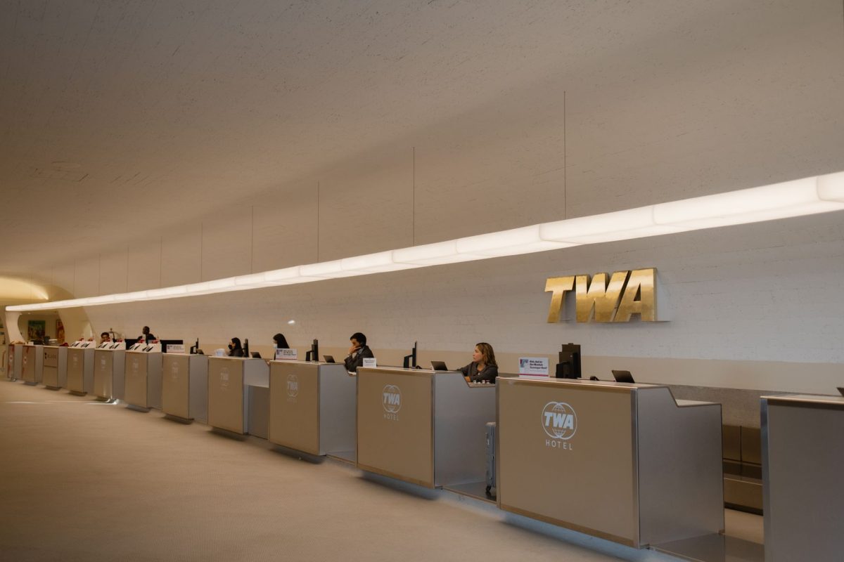 Reception desks at TWA Hotel, showcasing retro modern design in JFK Airport, New York.