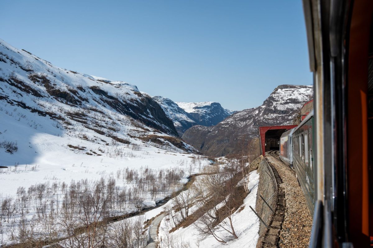 Experience an unforgettable train ride through snow covered landscapes and majestic fjords in Flåm, Norway.