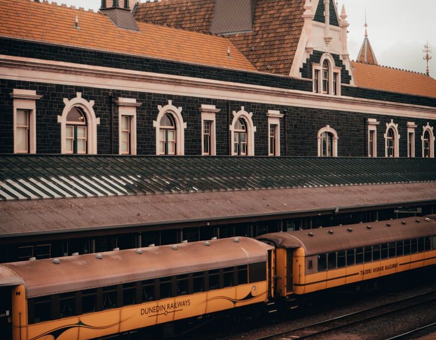 Captivating view of the historic Dunedin Railway Station, a striking example of Edwardian Baroque architecture in New Zealand.