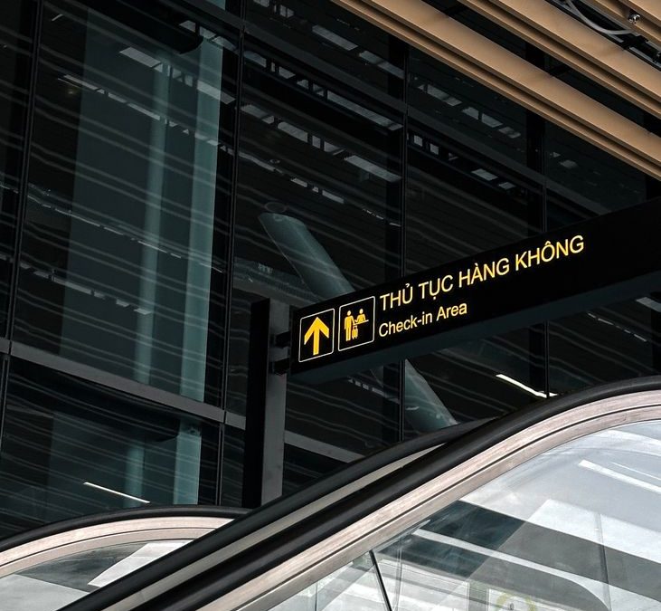 Modern airport interior with escalator and check in area sign at Ho Chi Minh City, Vietnam.