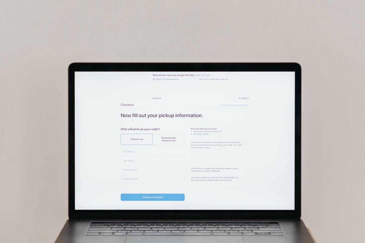 A laptop displaying an online checkout form, highlighting technology and e commerce.