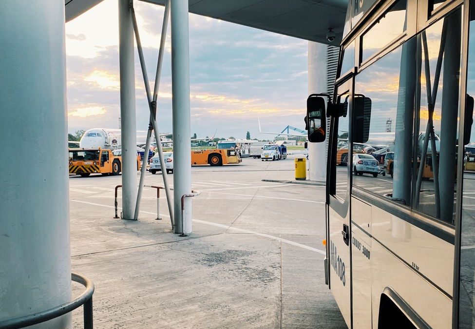 Contemporary airport view with buses and planes in Bucharest, Romania.