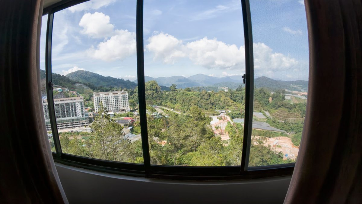 Breathtaking view of mountains and landscape through a window on a sunny day.