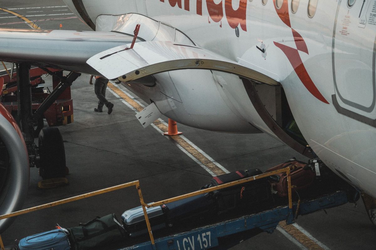 5 Bag-Drop Slipups That Can Derail a Travel Morning 3 Close up view of luggage being loaded onto an airplane at the airport.