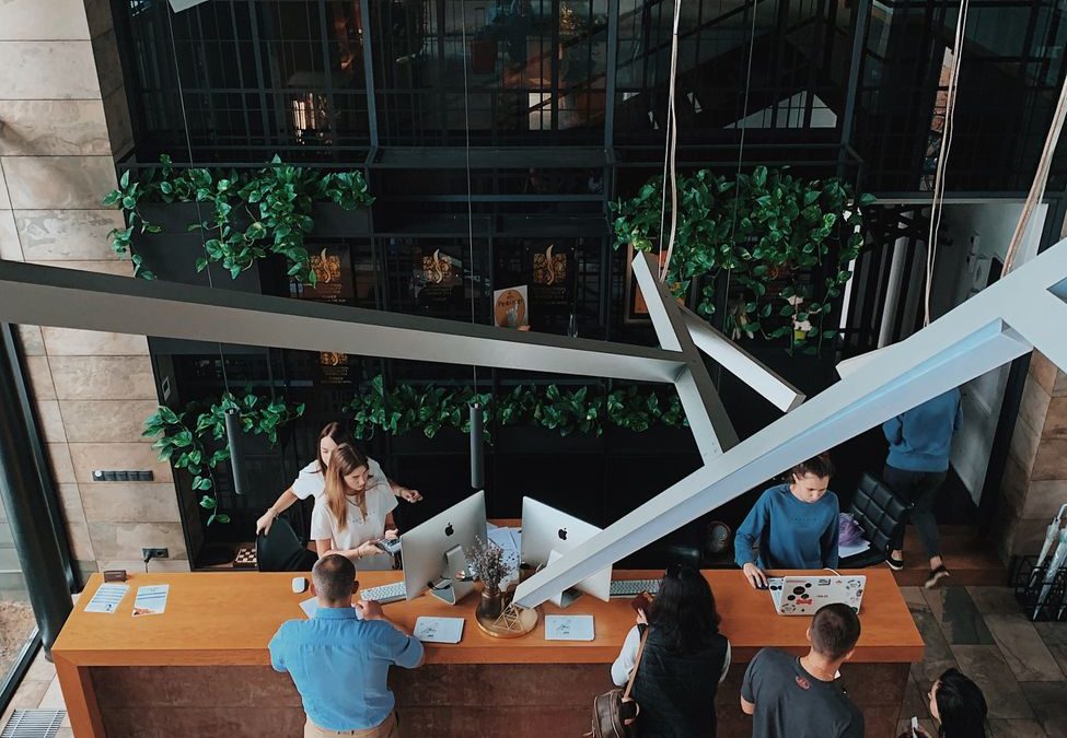 Aerial view of a modern hotel reception with people interacting at the desk in Sosnivka, Ukraine.