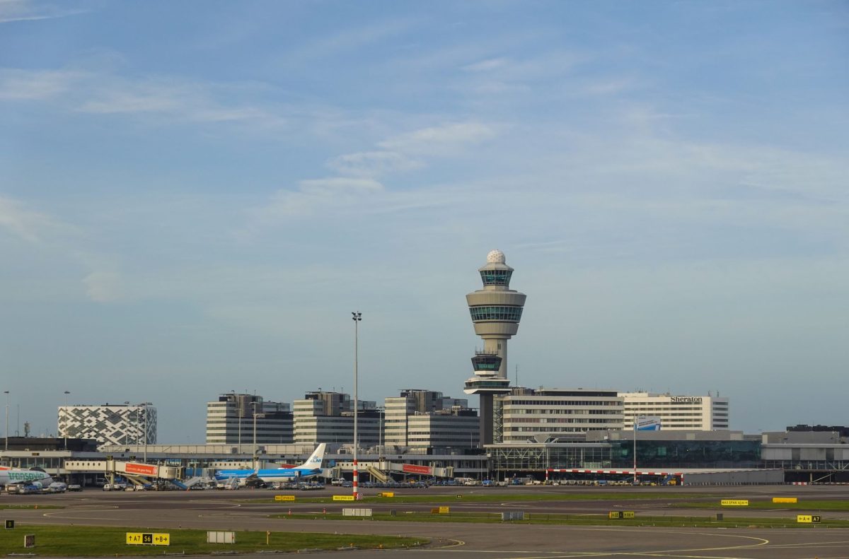 Panoramic view of Amsterdam&amp;amp;#39;s Schiphol Airport with control tower on a clear day.
