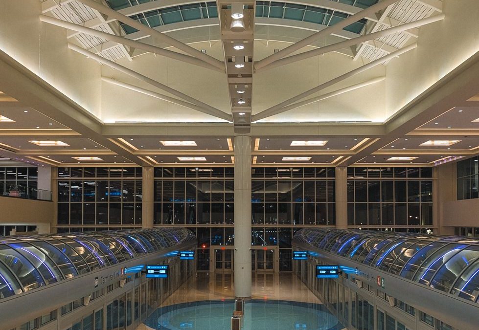 Spacious architecture of Orlando Airport terminal, showcasing sleek modern design and bright lighting.
