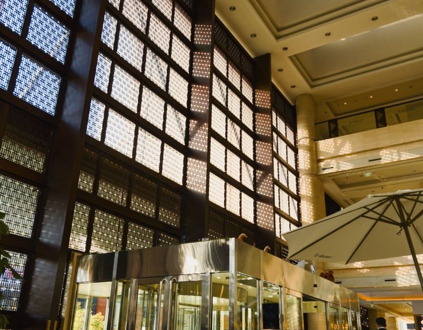 Spacious hotel lobby in Hohhot showcasing modern design with ample natural light and architectural elegance.