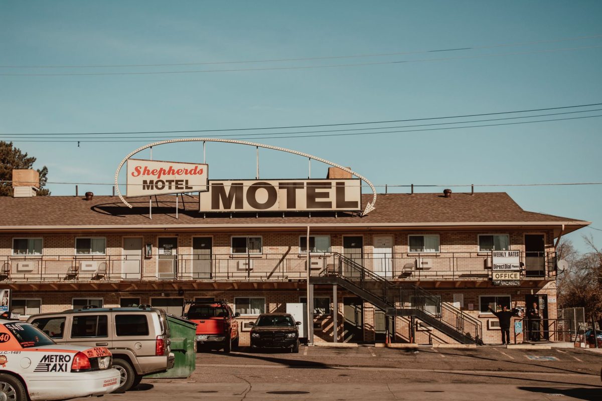 A nostalgic view of Shepherd&amp;#39;s Motel with cars parked in front under a clear blue sky.