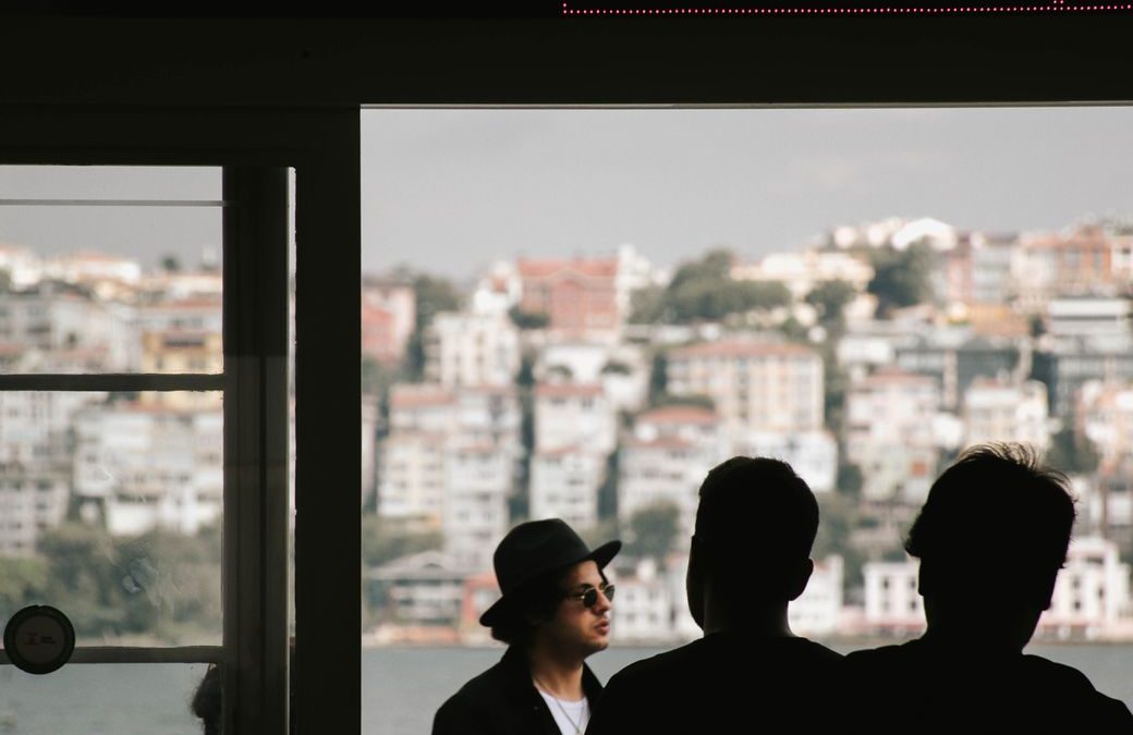 5 Ferry Boarding Habits That Keep a Short Crossing From Feeling Like a Fire Drill 1 Silhouetted people waiting at Kadikoy ferry terminal with cityscape in the background.