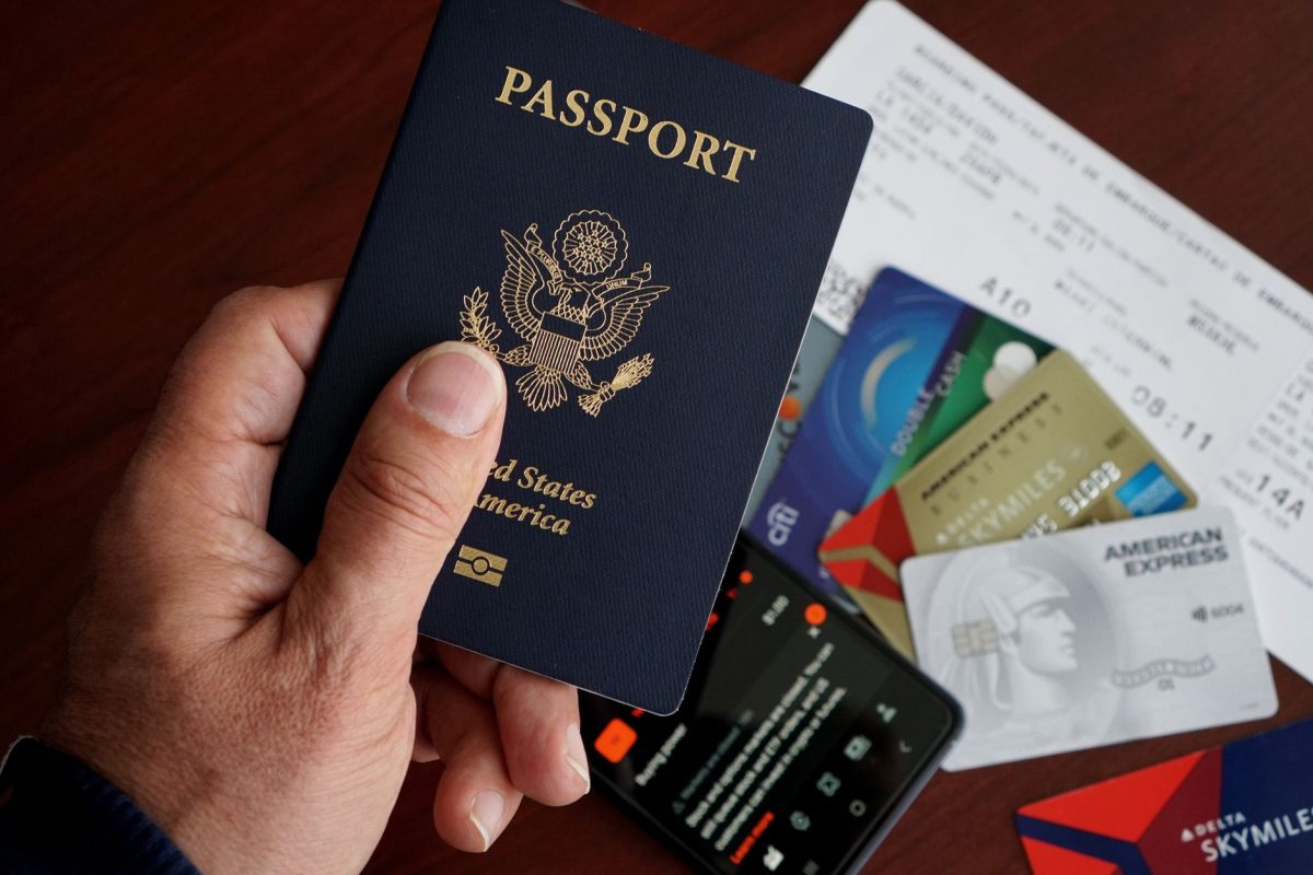 5 Hotel Habits That Make Travelers Seem Unprepared 2 A close up of a US passport with credit cards, tickets, and a mobile phone on a table.