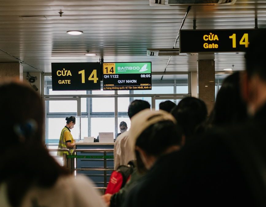 People standing in line at an airport gate, waiting to board a flight.