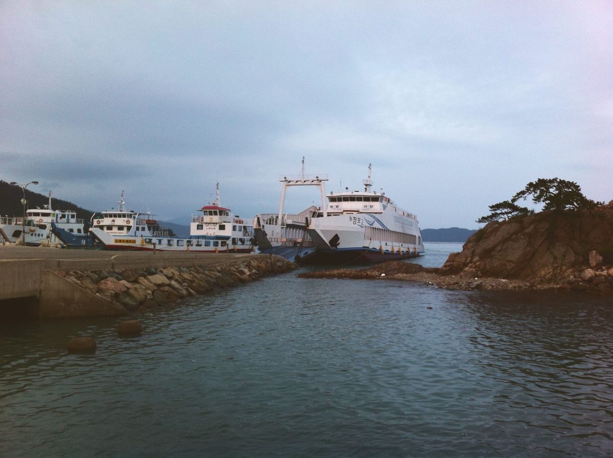 Ferries docked at Haenam pier surrounded by rocky terrain and calm sea.