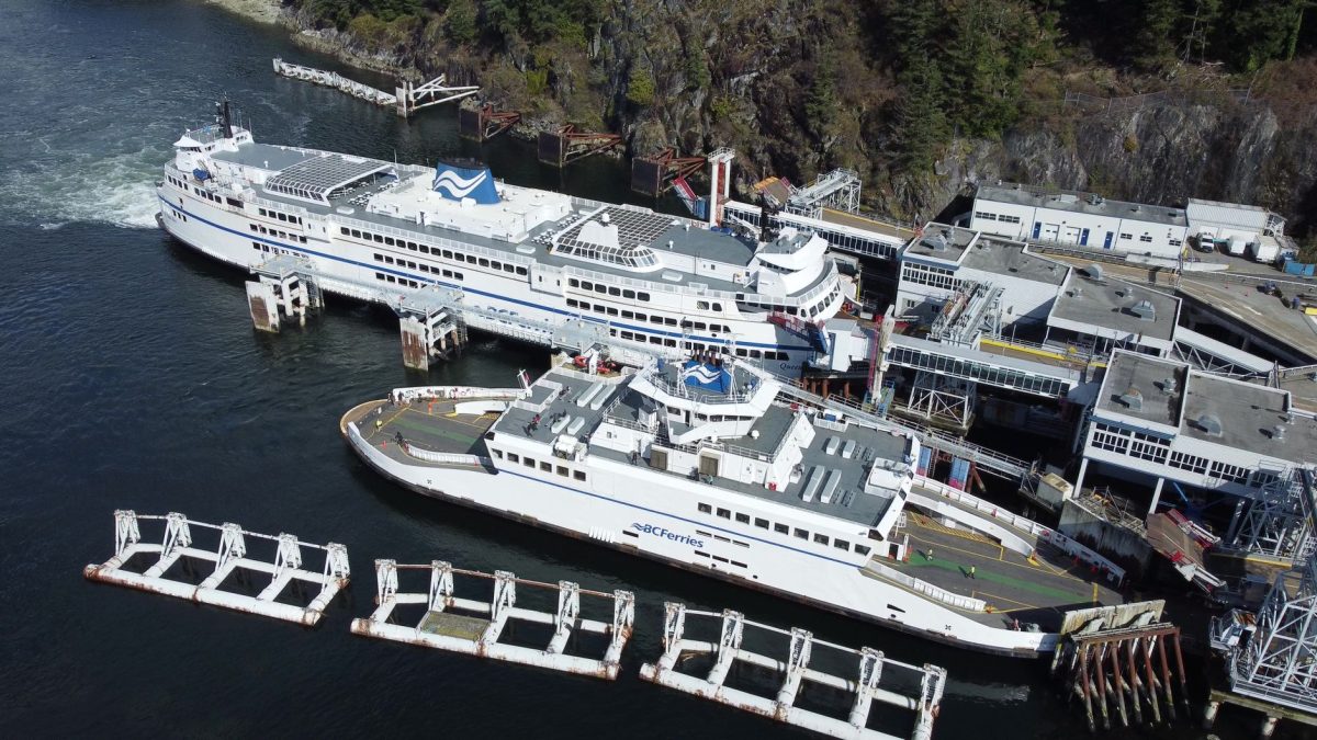 Aerial photo of large BC Ferries docked at a scenic coastal terminal